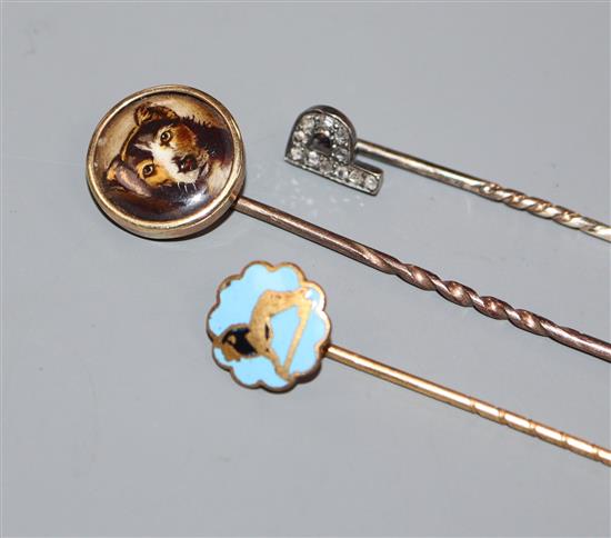 An early 20th century diamond set initial stick pin and two other stick pins.